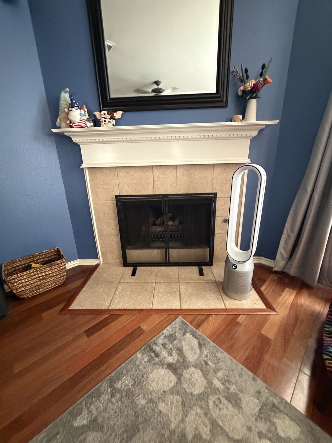 Before: fireplace with a dated tile surround and white mantel